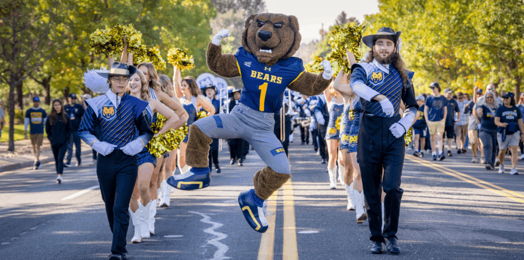 Klaws, the UNC mascot, jumps in the air as the marching band performs during the 2025 Independence Day Parade.