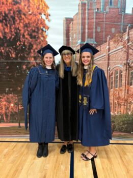 Alumni, Trista Romocki and Jennifer Cuypers pose for a picture with School of Teacher Education Director, Deborah Romero