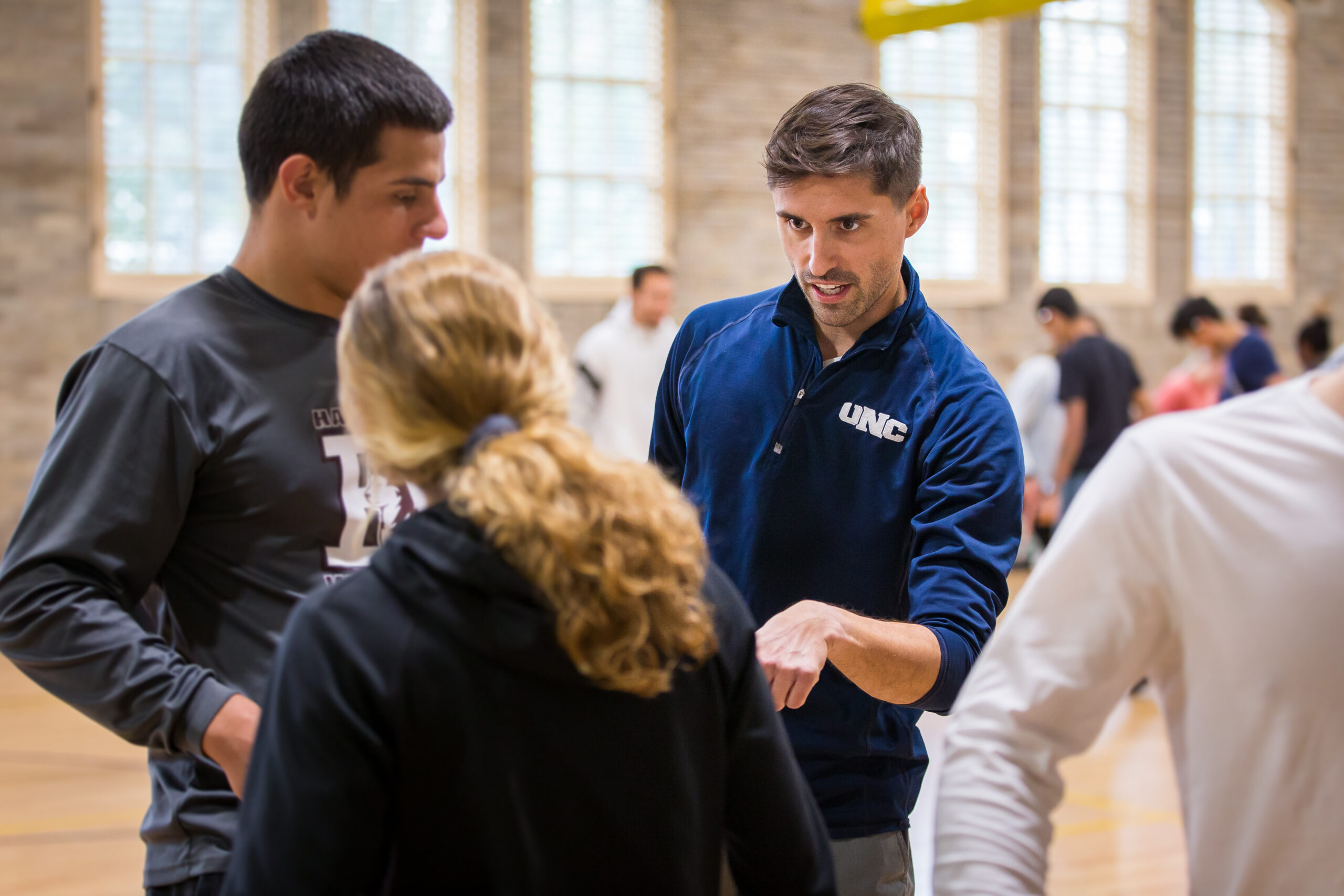 Teacher guiding students on different movements for exercise science