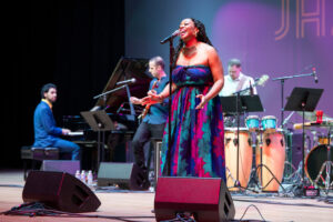 Alicia Olatuja singing on stage at the 2026 UNC•Greeley Jazz Festival.