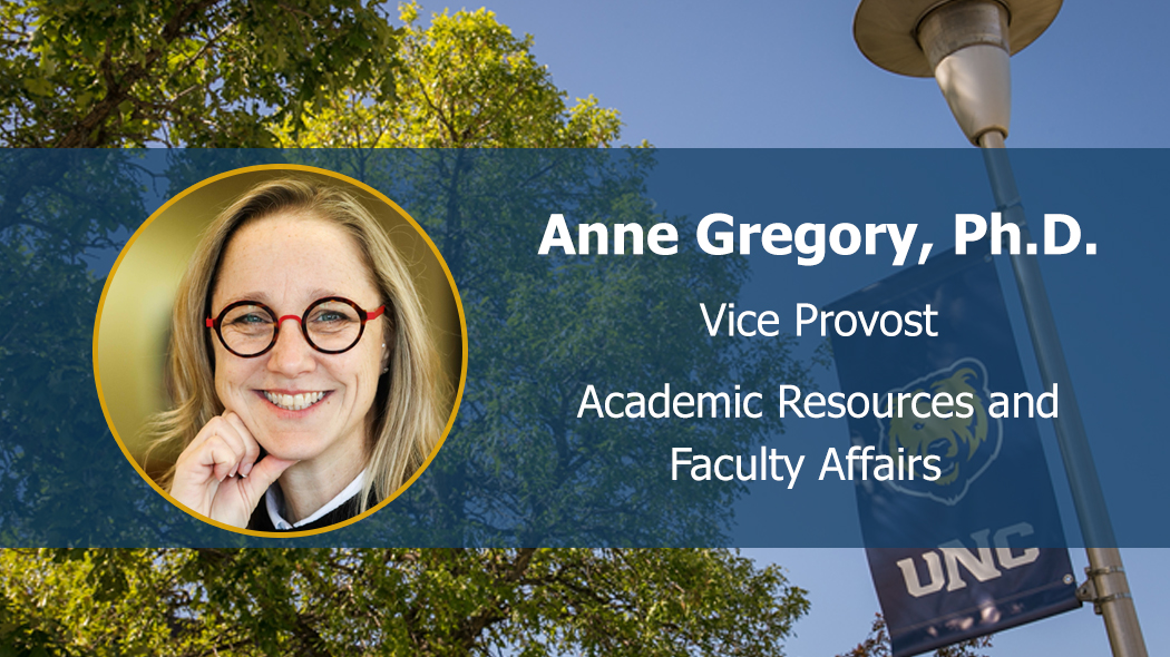Photo of Anne Gregory, facing forward and smiling on UNC-branded background