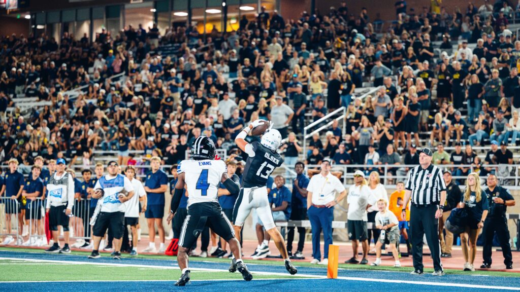 A UNC football player catching a touchdown pass