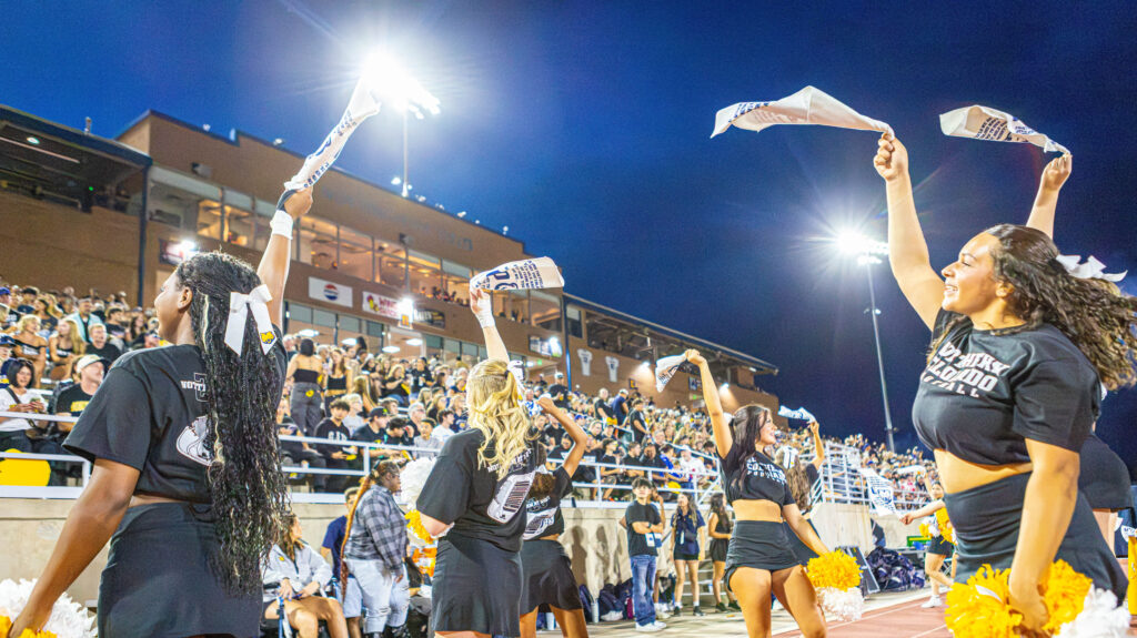 UNC cheerleaders holding up towels to the crowd