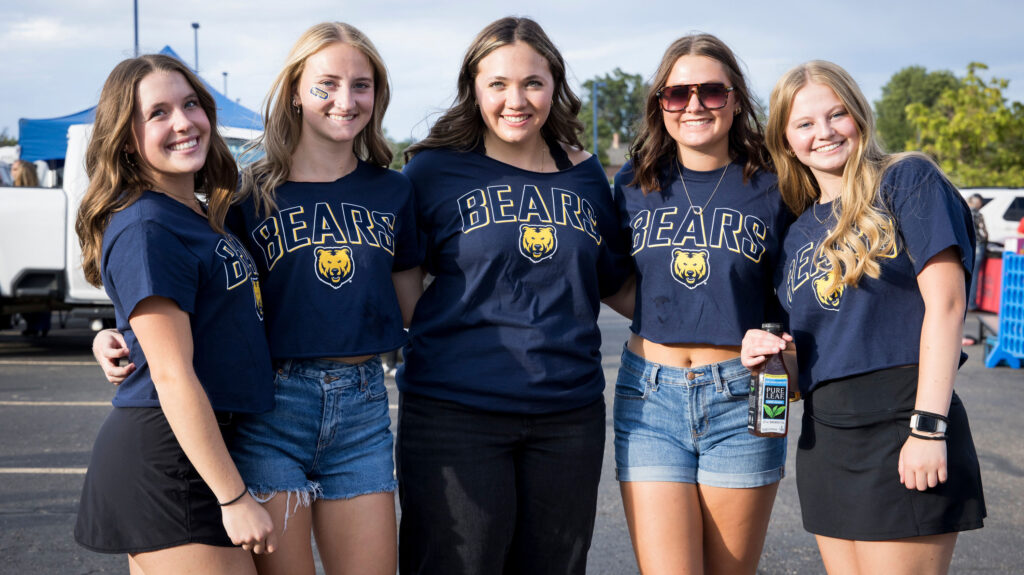 UNC students wearing shirts that says Bears smiling together