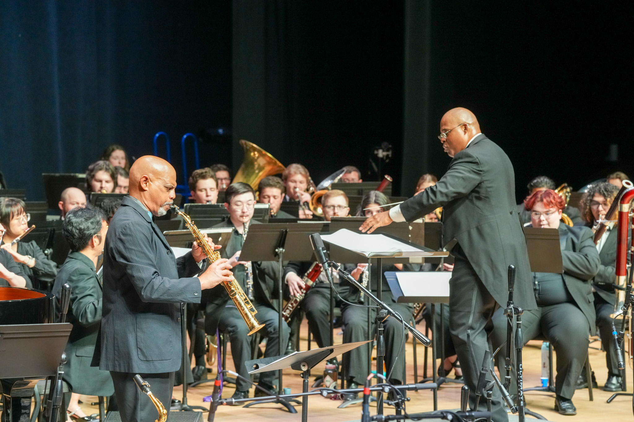 Guest saxophonist playing on stage with the UNC Wind Ensemble and conductor Wes Broadnax at the Harmonic Convergence concert in Fall 2025.