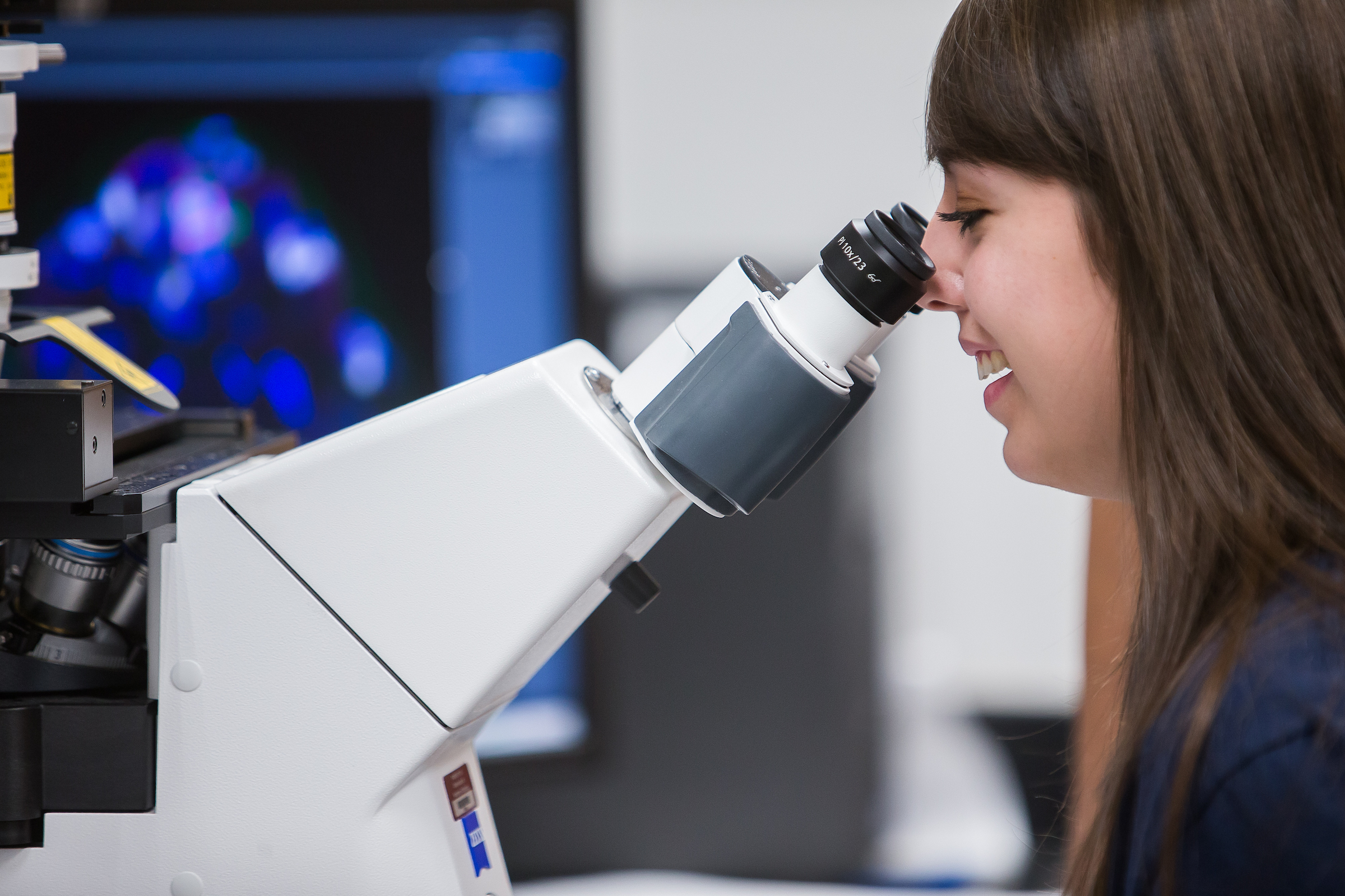 Student looking through microscope