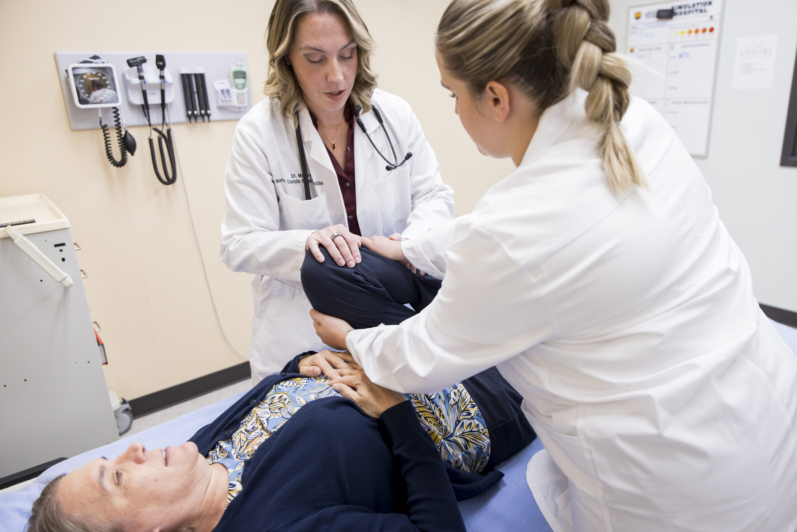 Two DO's working with patient.