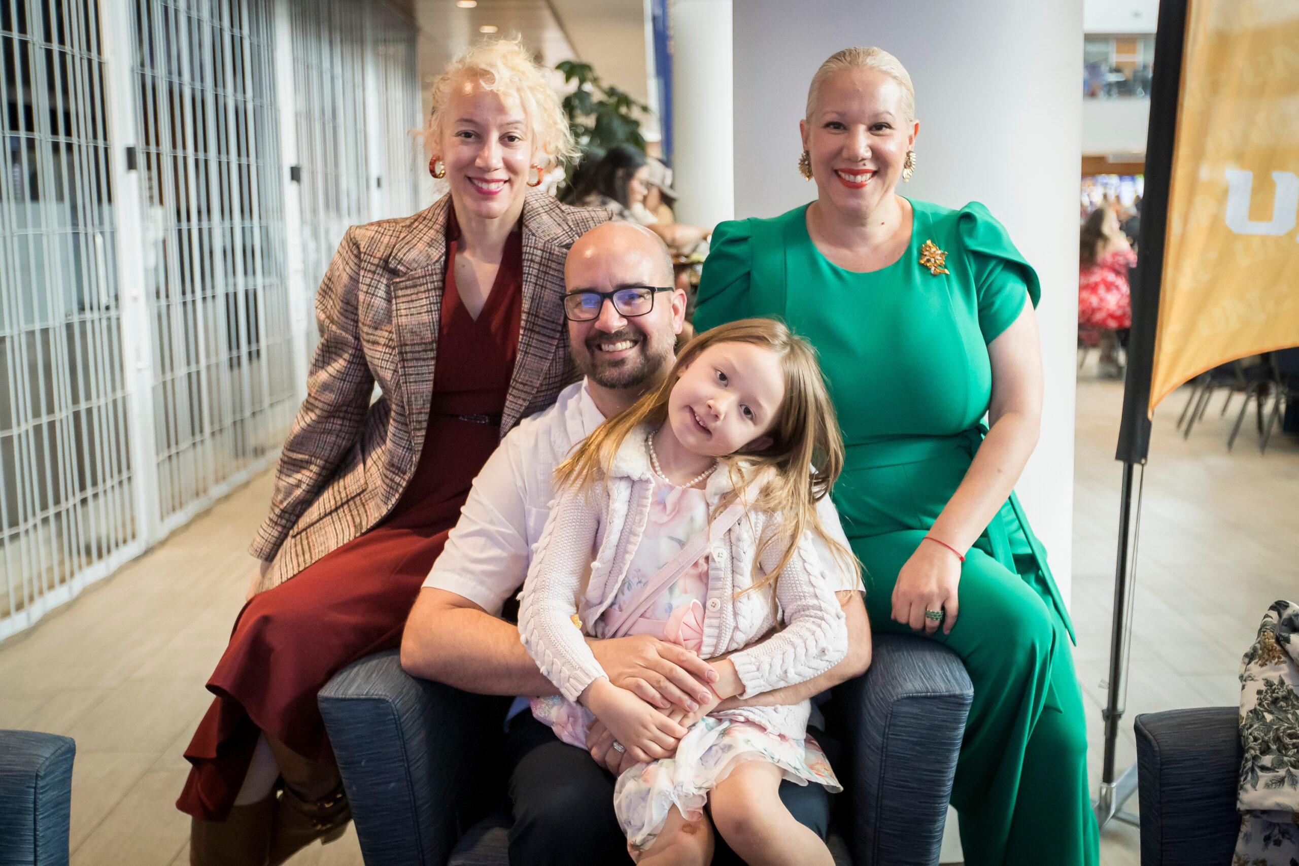 Grad student graduating in photo with family