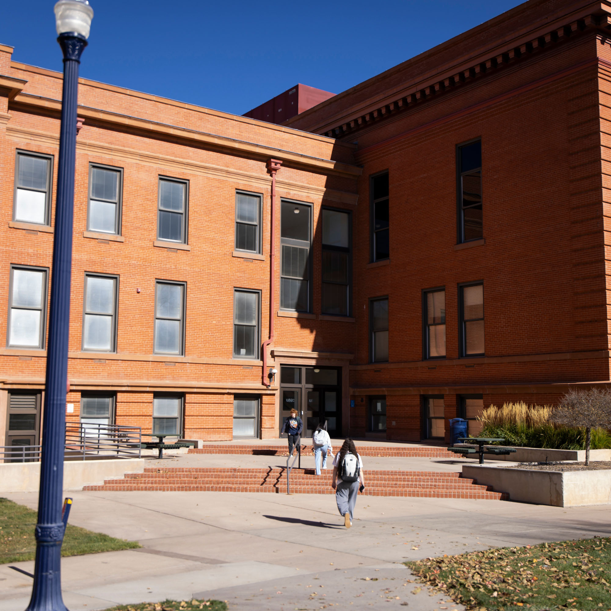 Kepner Hall, a red brick building with students walking in