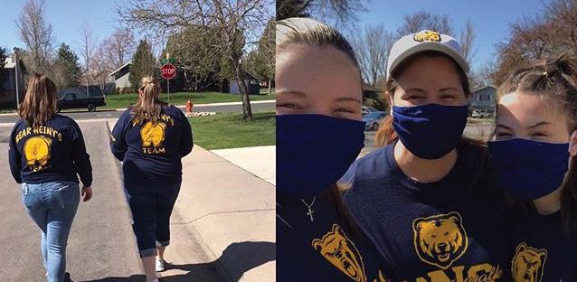 Two women wearing UNC gear walking with masks on