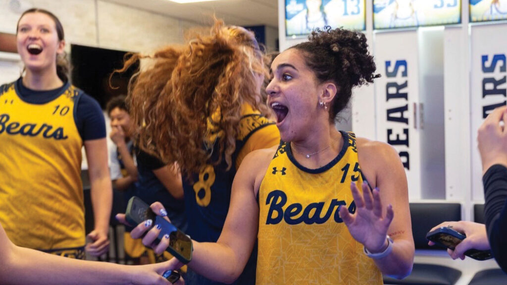 UNC Bear student-athlete reacts to new locker room with a big smile.