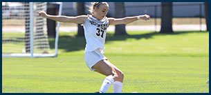 Number 37 women's soccer athlete kicking the ball down the field.