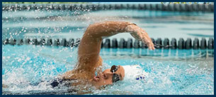 a woman swimming athlete in mid stroke.