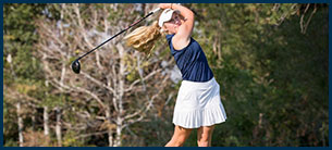 Woman golfer in a full back swing