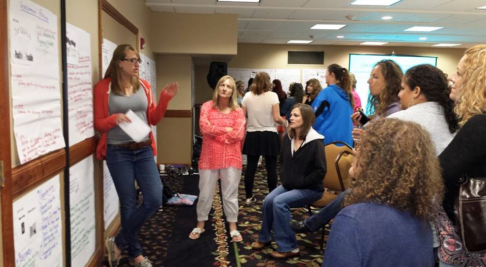 Summit attendees listening to a speaker