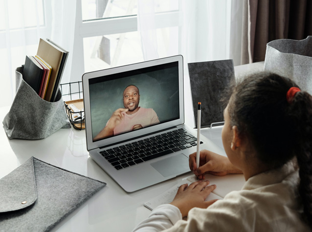 Photo of elementary student attending a student success session online