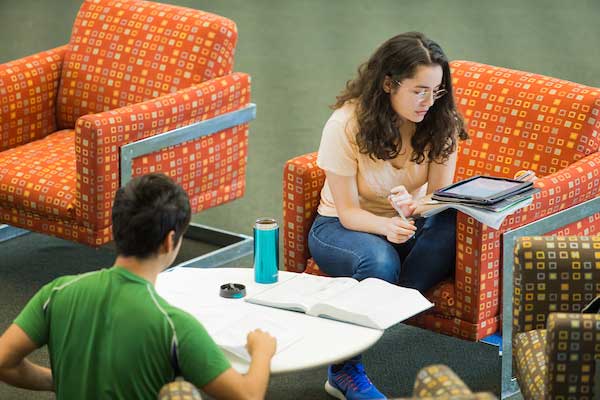 Students sitting in chairs, reading