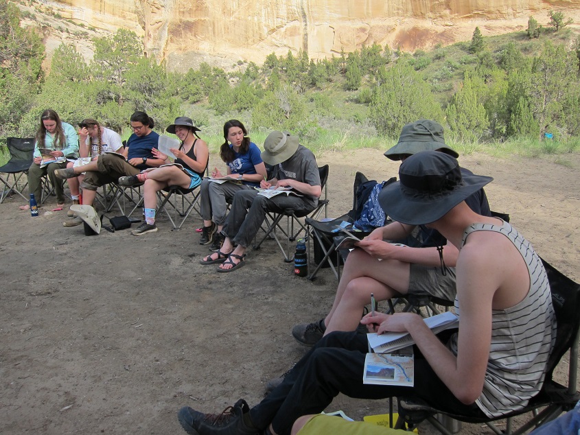 students writing in field journal