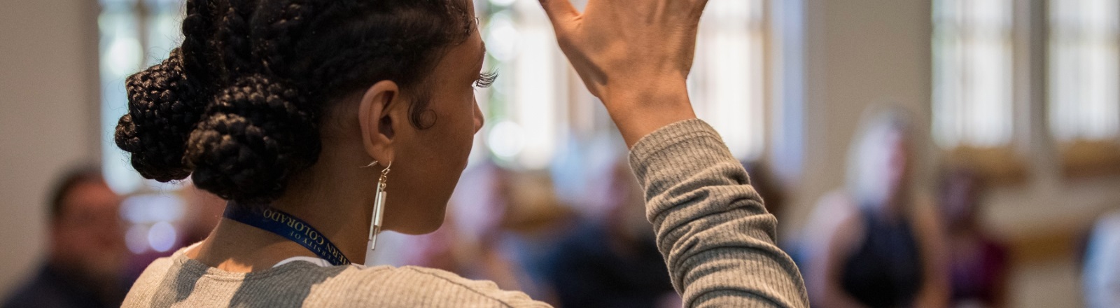 A POC individual presenting in front of a group