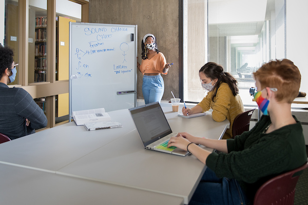 Four students in a study room in Michener Library