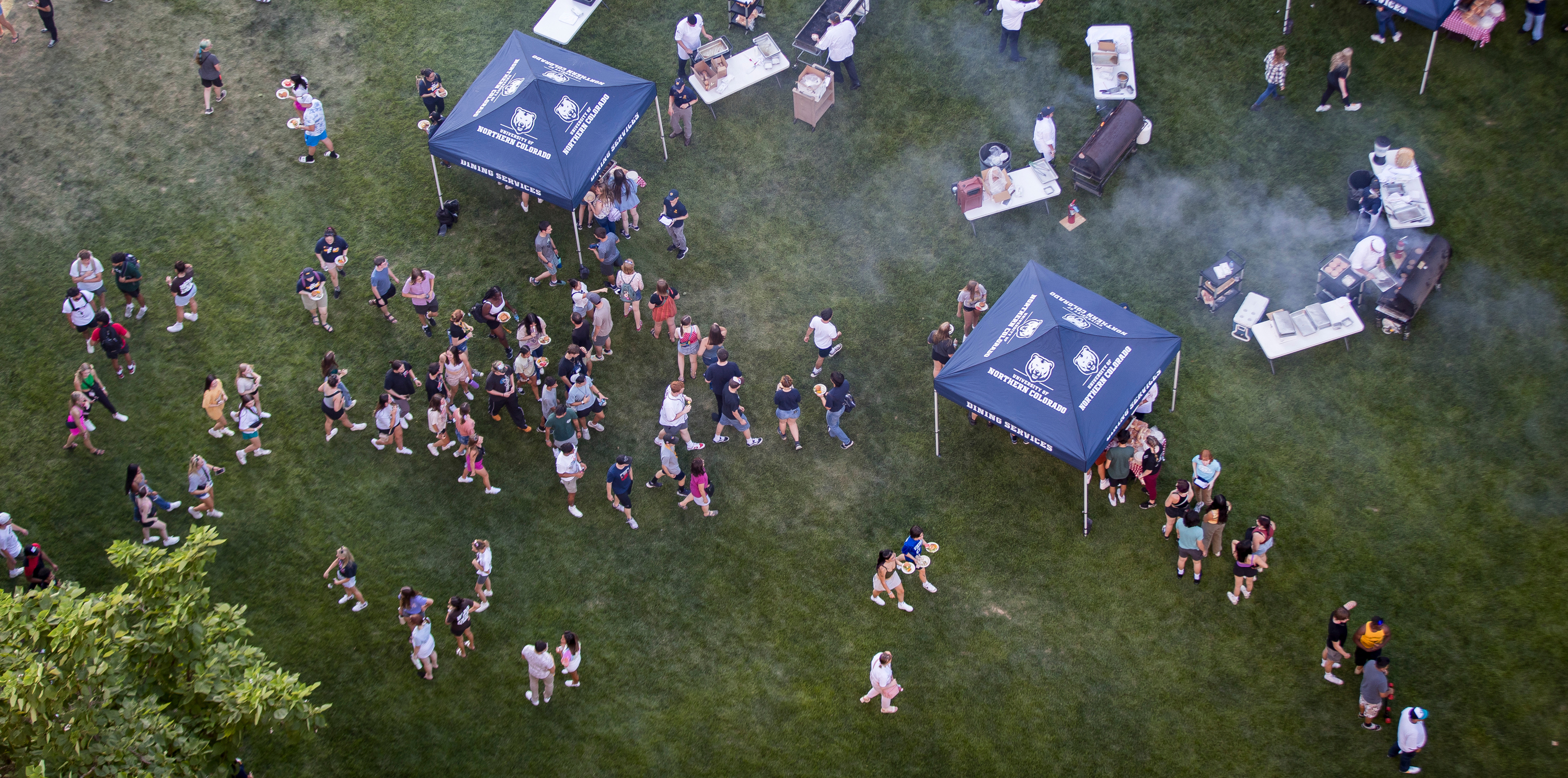 An overhead shot of new students walking around a grassy area on campus