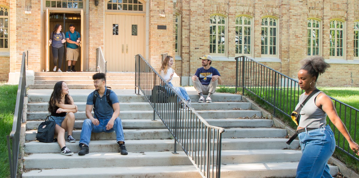 Students walking and sitting on campus.