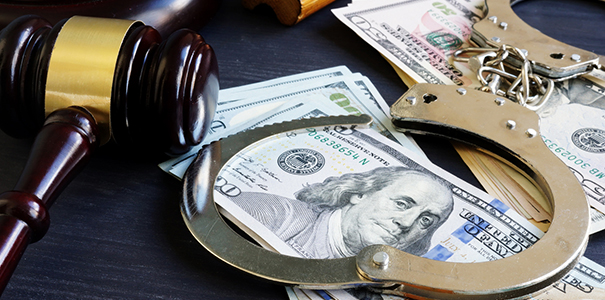 Photo of money, handcuffs and a judge's hammer