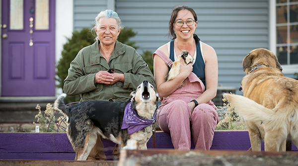 Two women holding animals