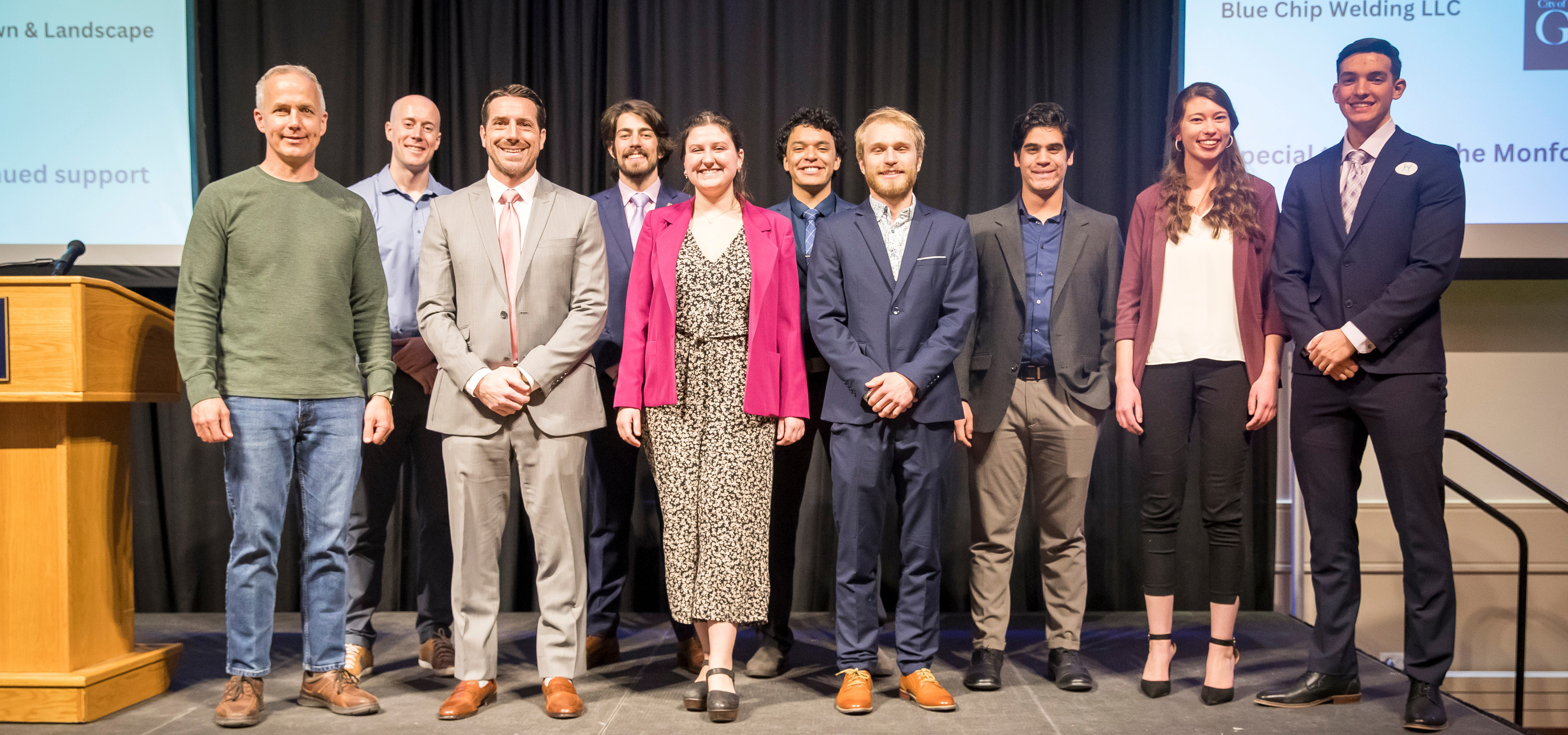 The winners standing next to each other and smiling