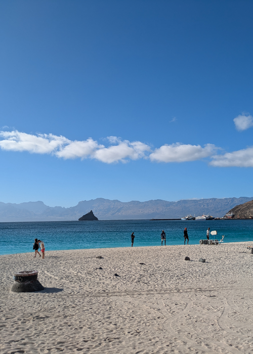 A beach in Cabo Verde with blue skies and dark sand