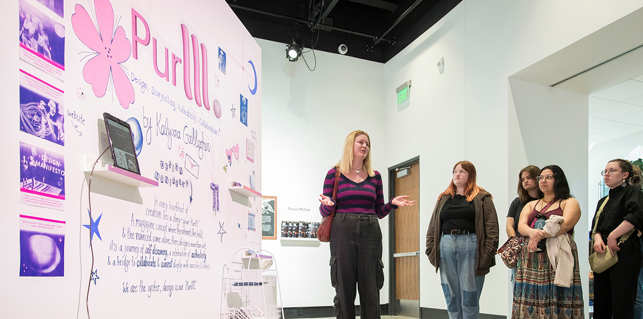 Students standing in front of artwork depicting Purlll magazine.