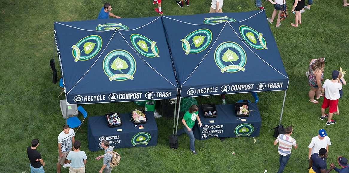 A birdseye view of tents that say reduce, reuse, recycle on campus