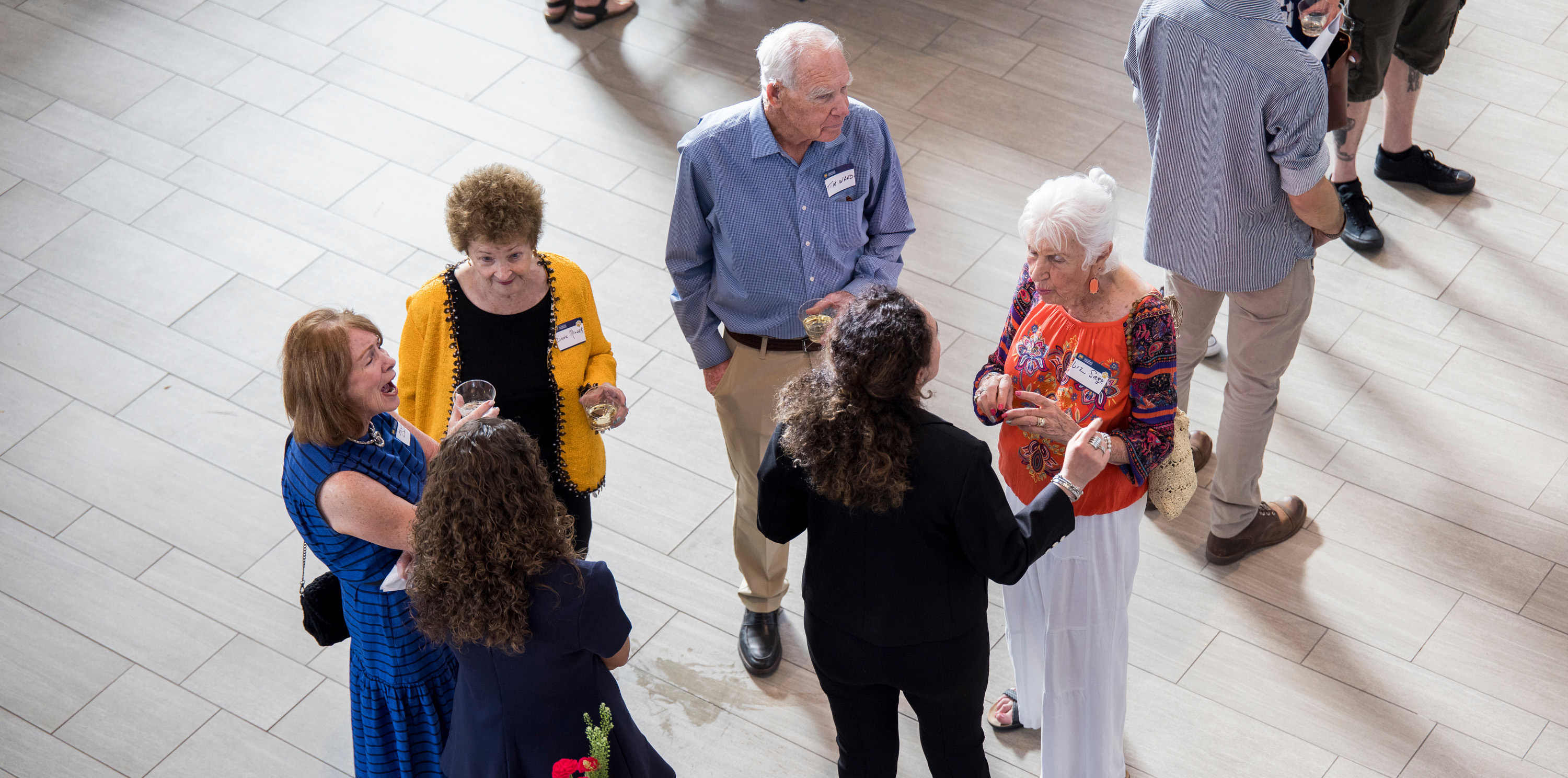 A birdseye view of people standing in a circle and smiling