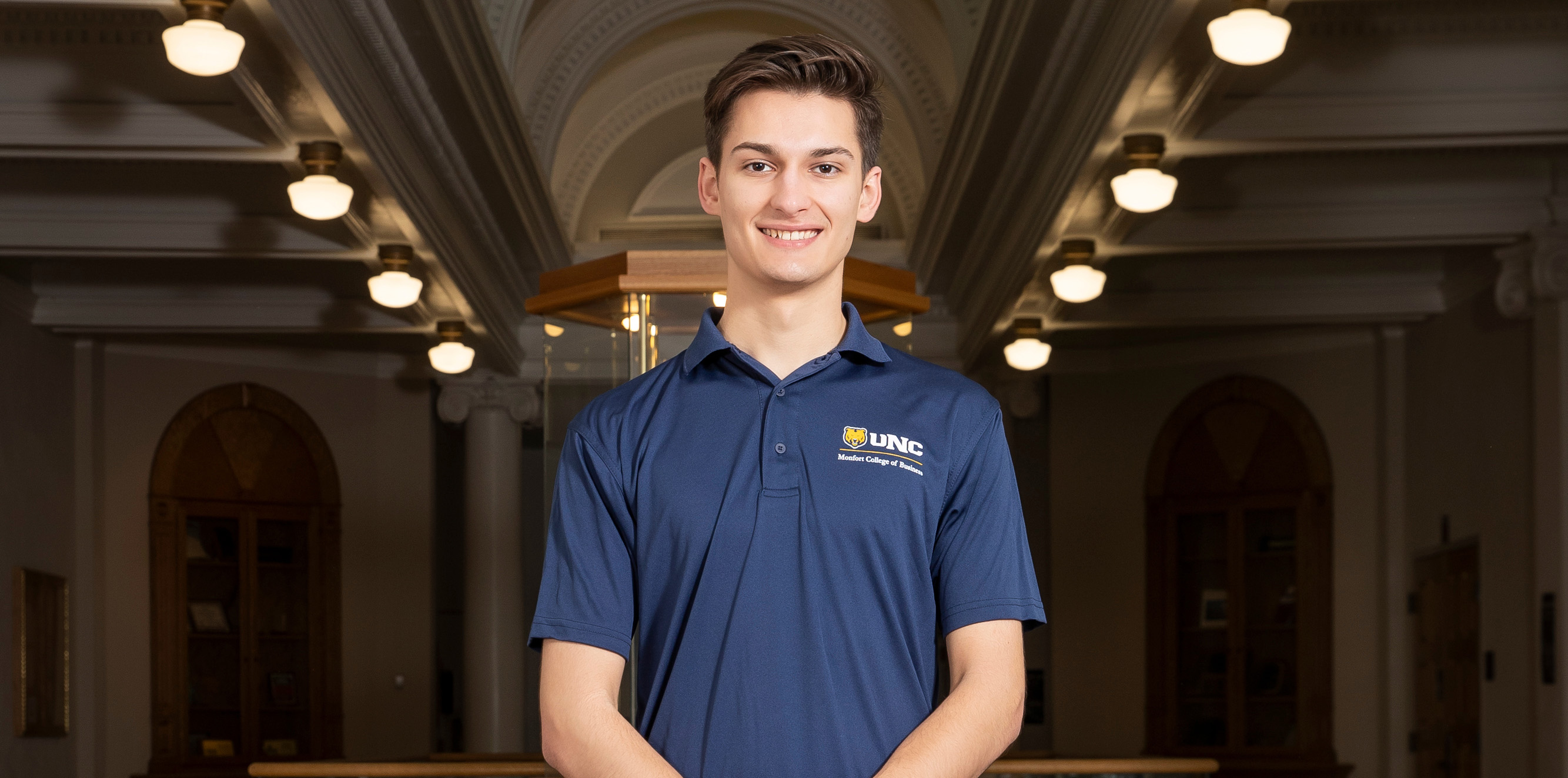 A profile shot of Philip Marshall wearing a navy polo shirt and smiling