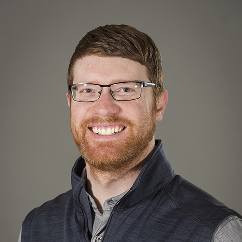 Sam Waters facing front and smiling.