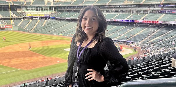 Sarai Atchison standing in the stands of an empty Colorado Rockies stadium