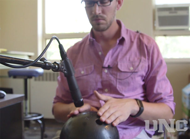 Todd Swingle playing the bowling ball with his electronic music on video.