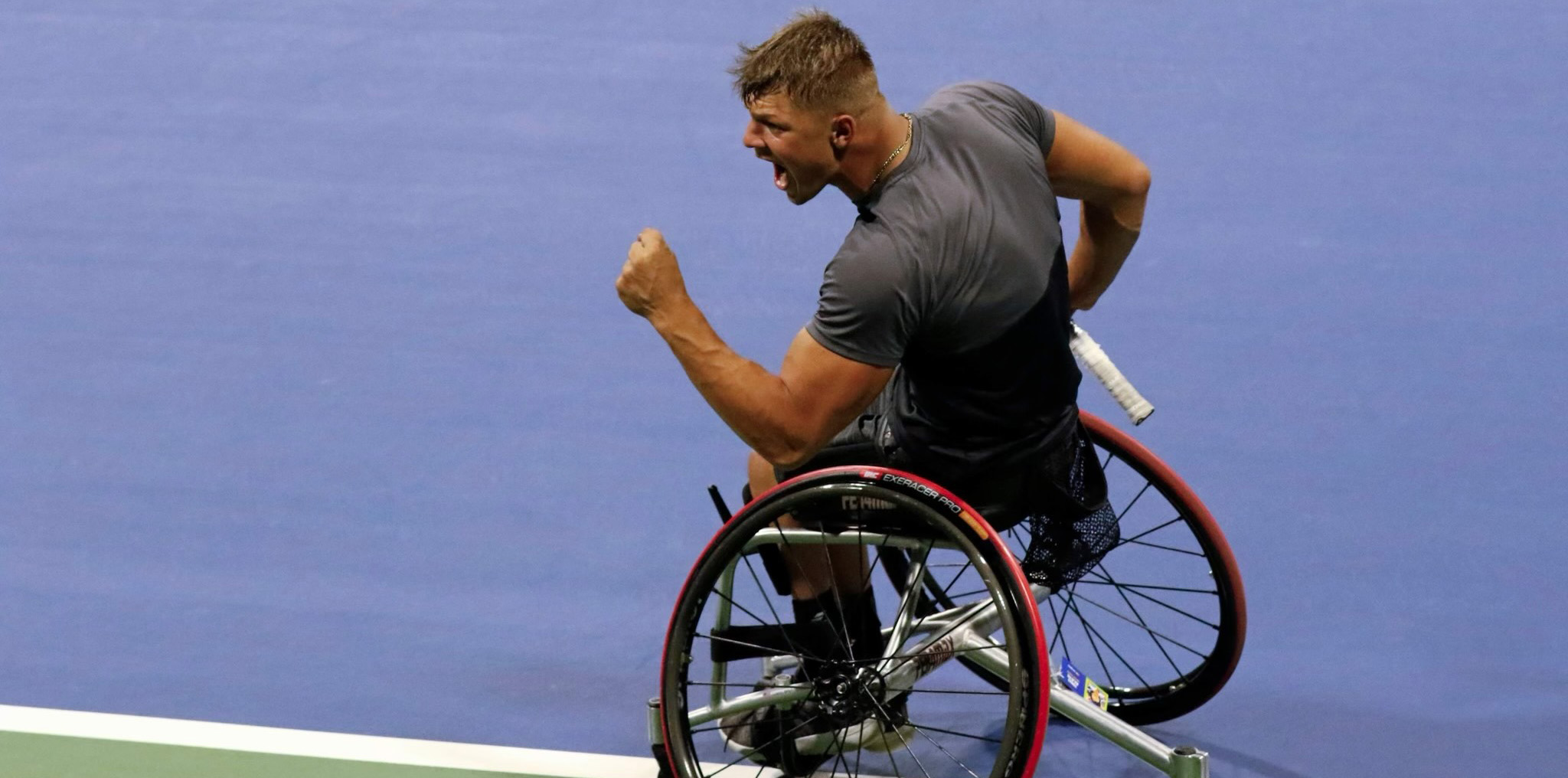 Tomas playing wheelchair tennis at the US Open clinching his fist in celebration