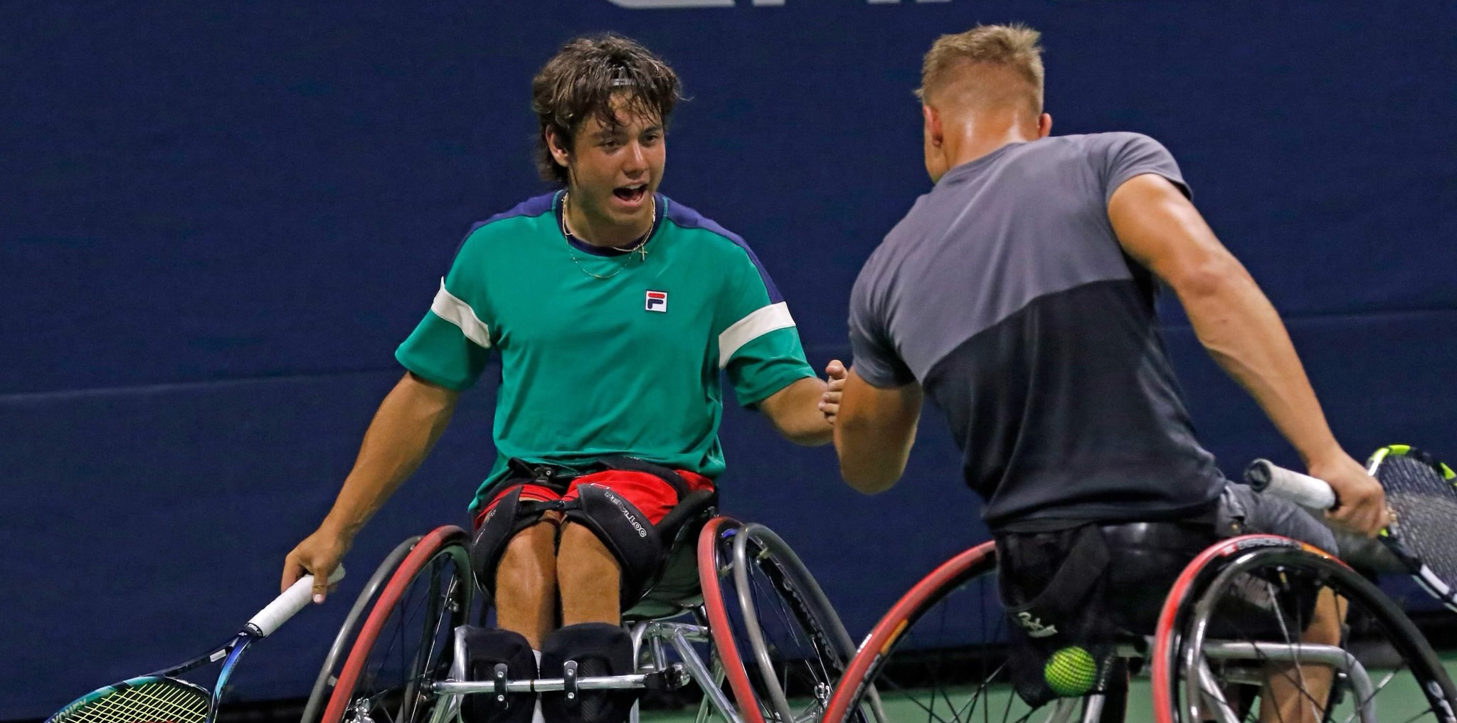 Tomas giving his partner a high five while playing wheelchair tennis in the US Open
