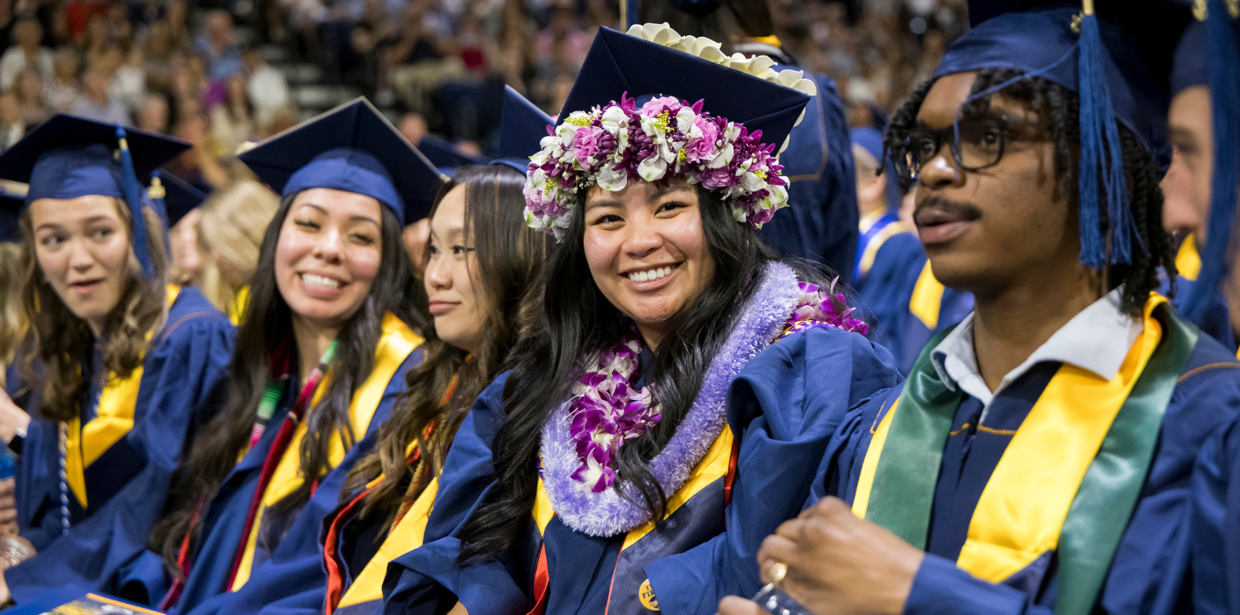 A group of students smiling during commencement.