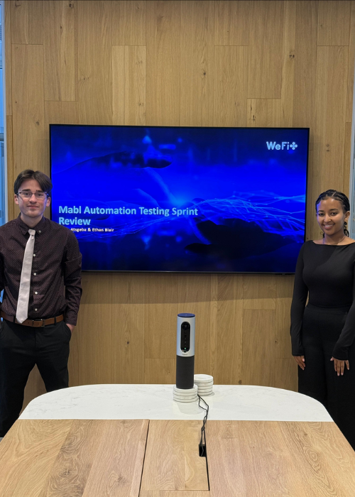 UNC students Ethan Blair and Rufta Atsgeba presenting on an IT topic during their internship