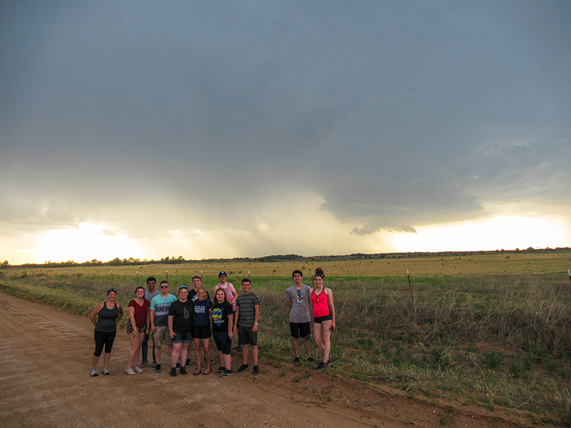 Students in front of a thunderstorm