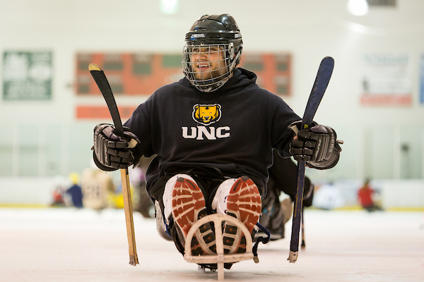 student playing sled hockey
