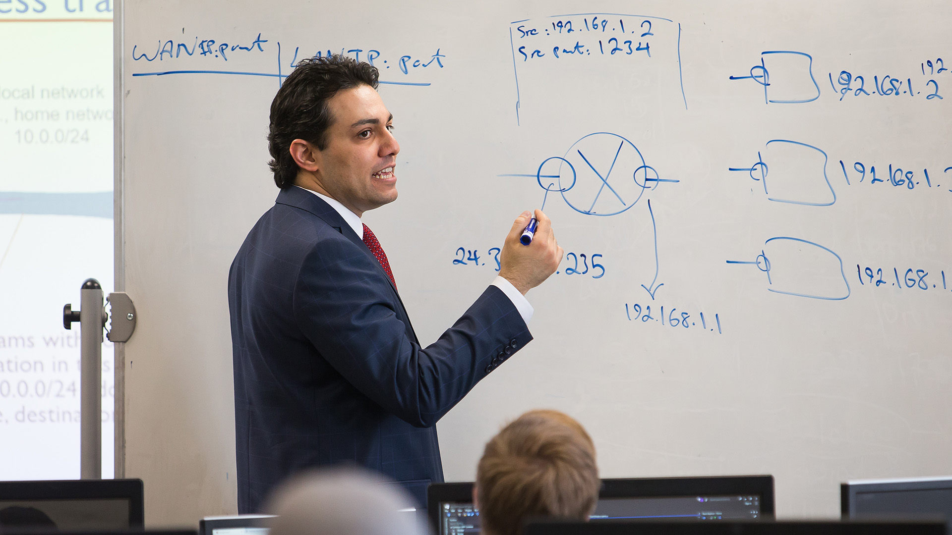 UNC Statistics Professor writing on a white board.