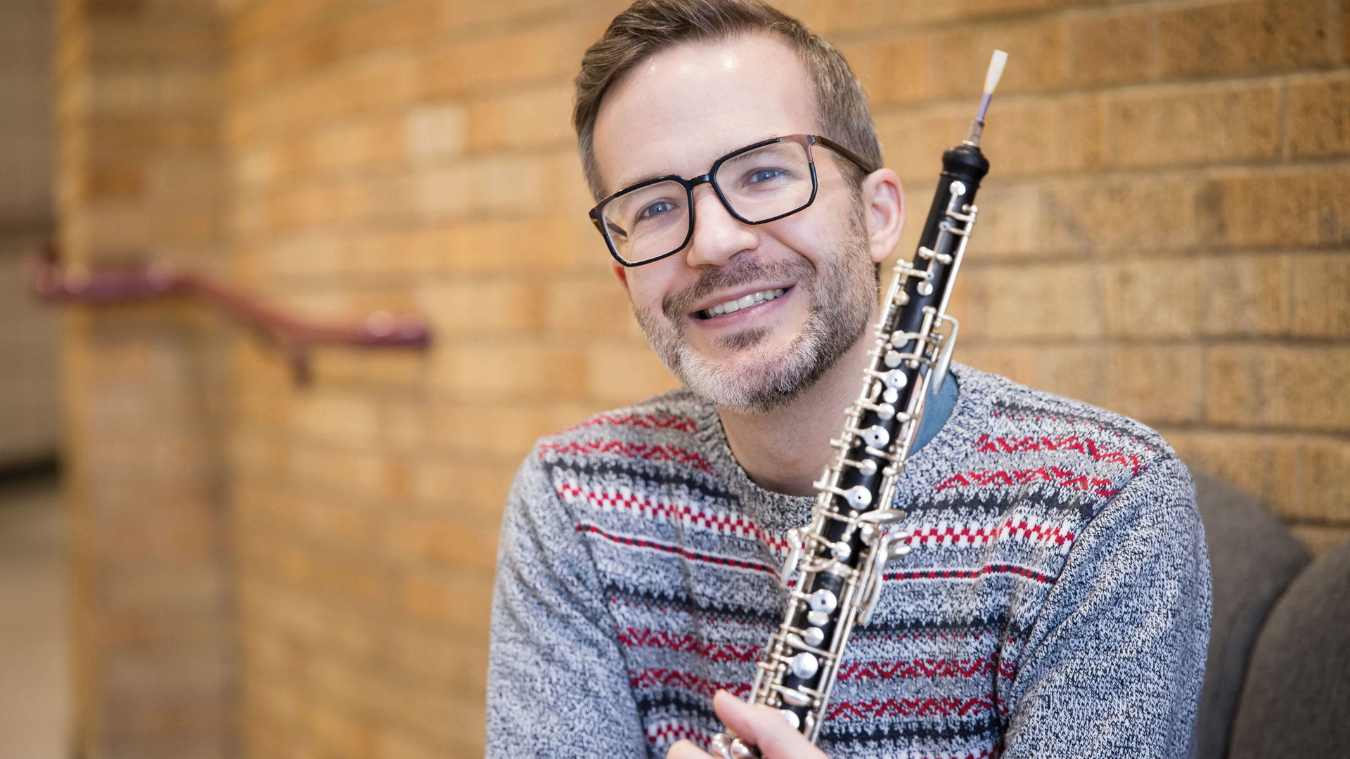 Tim Gocklin sitting with his Oboe