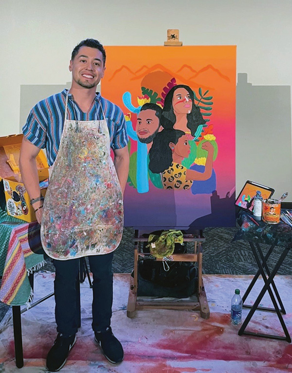 Julio Mendoza stands in front of his art.